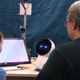 Lead researcher Brian Scassellati and a child interacting with Jibo the robot.